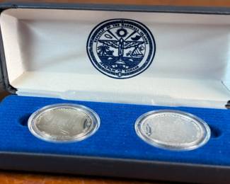 This lot features a John Glenn Returns to Space Commemorative Coin Set that includes a $50 .999 fine silver coin, along with a $5 solid cupronickel coin, circa 1998. Comes in the original presentation case with a certificate of authenticity. It commemorates John Glenn’s historic 1998 space shuttle flight aboard the Discovery (STS-95), when he became the oldest person to fly in space. 

