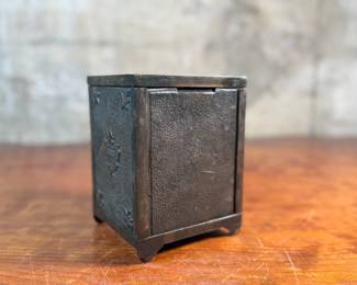 This lot features an antique cast iron bank known as, “The Keyless Safety Deposit Box”. Locks and unlocks as it should and measures, 6” H x 4.5” W x 4” D.

