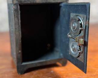 This lot features an antique cast iron bank known as, “The Keyless Safety Deposit Box”. Locks and unlocks as it should and measures, 6” H x 4.5” W x 4” D.

