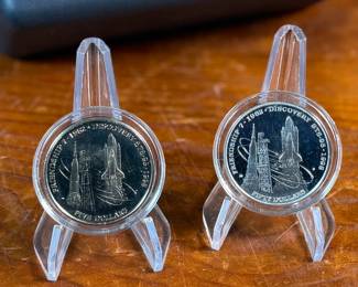 This lot features a John Glenn Returns to Space Commemorative Coin Set that includes a $50 .999 fine silver coin, along with a $5 solid cupronickel coin, circa 1998. Comes in the original presentation case with a certificate of authenticity. It commemorates John Glenn’s historic 1998 space shuttle flight aboard the Discovery (STS-95), when he became the oldest person to fly in space. 


