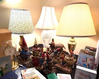 A Waterford crystal table lamp, vintage Stiffel brass table lamps, a vintage German torsion clock and Tom Clark Gnomes collection by Cairn Studios. 