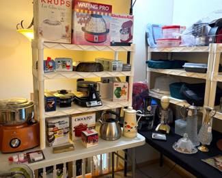 Cook's Companion stand mixer, Hamilton Beach appliance box, a Crock-Pot portable food warmer, a stainless steel kettle, and a decorative ceramic pitcher, a Waring Pro WPM10 Popcorn Maker, Krups 358-70 La Glacière ice cream maker, KitchenAid Ice Cream Maker Attachment, Revel CTM-680 Tortilla & Flatbread Maker. A vintage Oster blender and set of vintage Leonard crystal and silver-plate decanters. 
