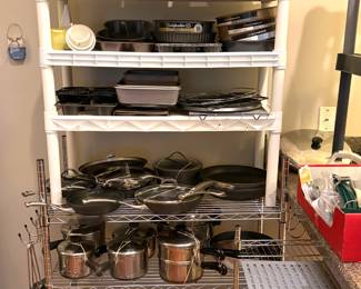 A collection of various bakeware items, including springform and Bundt pans.  A collection of pots, pans, and baking dishes  
including stainless steel and nonstick cookware. Featuring brands like Calphalon.
