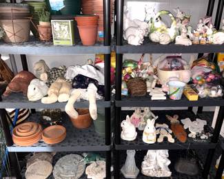 Outdoor garden figurines, pots and a collection of ceramic bunnies. 