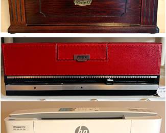 A Thomas Pacconi Classics turntable record player. A DiscGear Selector 120HD faux leather CD/DVD storage case in red and a HP DeskJet 3752 All-in-One Printer.