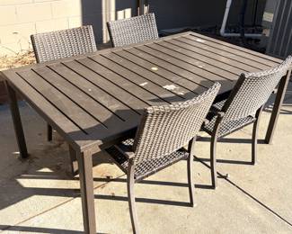 Alumium outdoor patio table with 4 matching all weather woven resin wicker chairs. 