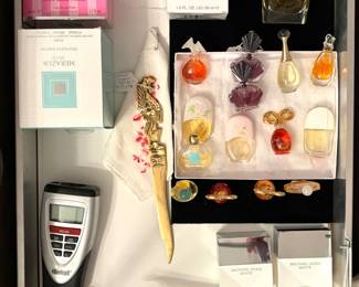 A collection of vintage and modern perfumes, including: A Michael Kors White Eau de Parfum Spray, a large Christian Dior Diorama Eau de Toilette bottle and a collection of miniature perfume bottles, including  "Diorissimo"
A Calculated Industries 6025 Scale Master Pro digital plan measure, and a vintage solid brass letter opener. 