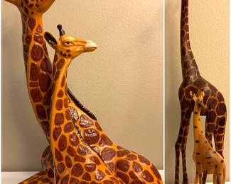 A vintage glazed ceramic giraffe figurine and  a set of hand-carved wooden mother and baby giraffe figurines. 