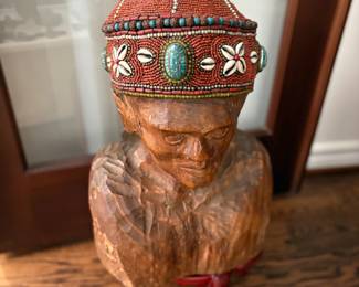 . . . wood carved figure with beaded hat