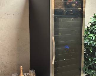 Wine fridge with several bottles of wine