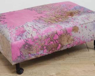 Contemporary cowhide ottoman on casters