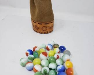Collection of vintage marbles in a leather pouch
