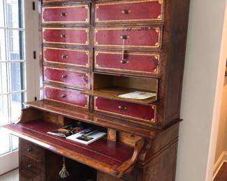 Beautiful & historic English secretary ca. 1820, with red leather drawer fronts. It is pictured in Architectural Digest issue September/October 1976 in the home of Film Maker Freddie Fields, pictures of the issue following pictures of the secretary. 