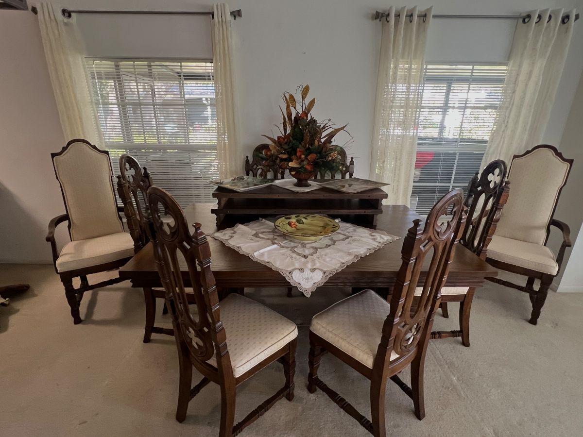 Stanley Gothic style dining room table with 6 padded seat chairs, 2 armed captains chairs,2extra leaves as well as   Table pads. Matching China cabinet sold separately 
