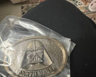 20th Century Fox , 1977 Darth Vader brass belt buckle . We also have vintage political buttons,action figure accessories and food chain promotional items