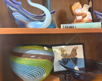glass swan figurine, books, framed butterfly art, murano glass goldfish vase