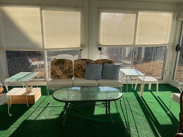 Vintage metal outdoor furniture. White loveseat, two metal tables and two chairs. Coffee table more contemporary