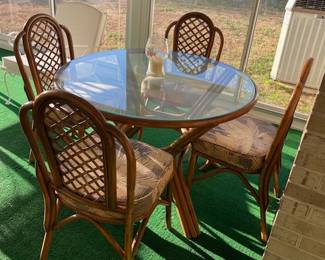 Rattan table with glass top and four chairs