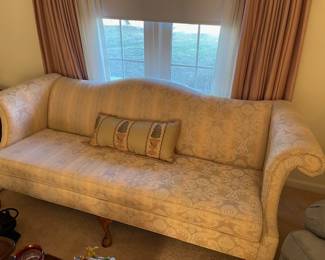 Camel back upholstered sofa