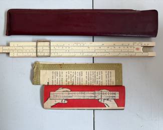 a collection of antique and vintage bone slide rules, tachometers, micrometers, calipers and calibration gauges