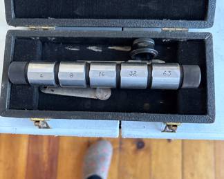 a collection of antique and vintage bone slide rules, tachometers, micrometers, calipers and calibration gauges