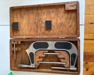 a collection of antique and vintage bone slide rules, tachometers, micrometers, calipers and calibration gauges