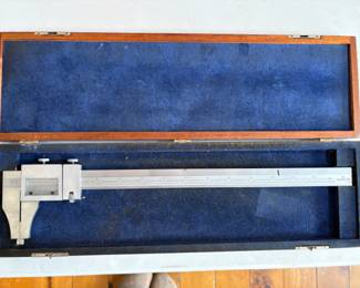 a collection of antique and vintage bone slide rules, tachometers, micrometers, calipers and calibration gauges