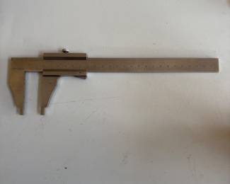 a collection of antique and vintage bone slide rules, tachometers, micrometers, calipers and calibration gauges