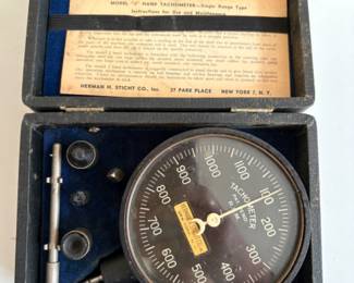 a collection of antique and vintage bone slide rules, tachometers, micrometers, calipers and calibration gauges