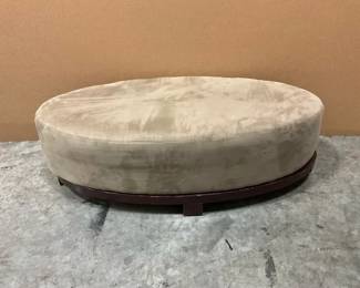 Oval Upholstered Ottoman With Dark Wood Base