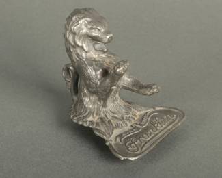 1925-1928 Franklin Automotive Mascot. In the shape of a lion. Measures 3 3/4" tall and 3" at the base. Reads Aura Vencit.