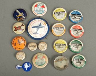 18 Aviation Related Pinbacks. Comes with one small ball game. Seven pins are bond bread. One of the yellow ones has a wrinkled surface. Two are Cleveland air race.