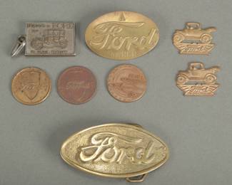 8 Ford Items. Includes 2 Fobs, 2 tokens dated 1933 and 1934 and one similar 1933. Ford owner brass pin. Ford R.O.C. brass belt buckle #584