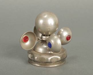 1930's Twirling Wiggler Automotive Mascot. 3 1/2" tall and 3 3/4" wide. Spins with 4 jewels.