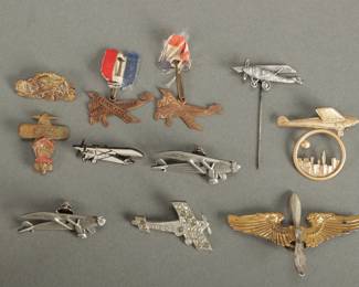 10 Spirit of St. Louis Pins. Also includes one wings with propeller. Measures 3" wide.