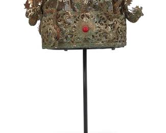 1053
A Chinese silver metal filigree wedding headdress
Qing Dynasty (1644–1912) or later
A large elaborate mixed metal wire and mesh crown with filigree border featuring dragon motifs and a central sunburst with set red stone, the top adorned with multiple sinuous dragons and long-tail roosters in metal foil and mesh, as well as floral and auspicious symbols, the crown mounted on a custom display stand
6.5" H x 10.5" W x 8.5" D (including decorations); Interior: 7.5" W x 6.75"D; 16.5" H on stand
Estimate: $2,000 - $3,000