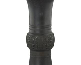 1054
A Chinese cast metal gu form archaistic vase
Song/Yuan Dynasty (960-1368) or later
With bird motifs to central lobe
12" H x 6.4" Dia.
Estimate: $800 - $1,200