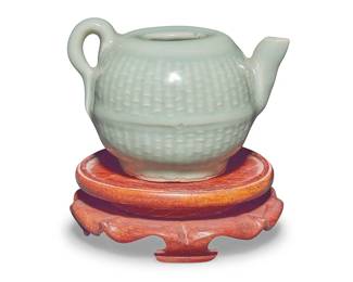 1024
A Chinese Longquan celadon basket weave water dropper
Yuan Dynasty (1271-1368) or later
Raised on a carved wood stand
Ceramic: 3.125" H x 4.375" W x 3.375" D; Stand: 1.5" H x 4.375" Dia.
Estimate: $700 - $900