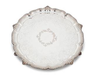 1005
A Victorian sterling silver round footed tray
1884
With London hallmarks; maker's mark: R & S Garrard [James Garrard]
The tray raised on scrolled feet, with a chased foliate medallion and scalloped rim
1.5" H x 15" Dia.
49.5 oz. troy approximately
Estimate: $3,000 - $4,000