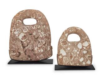 1091
Two fossil specimens
Circa 2000-1700 BCE
Each shell-imbued sandstone carved with a handle, set in an enameled metal stand, and raised on an acrylic plinth
2 pieces
Larger specimen: 14.75" H x 12.25" W x 2.75" D; Smaller: 10" H x 8.875" W x 2.75" D
Estimate: $400 - $600
