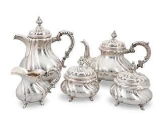 1003
A Bruckmann & Söhne silver tea and coffee service
Early/mid-20th century
With German hallmarks for .835 silver and maker's bird cipher
Comprising a coffee pot (10" H x 8.75" W x 5.5" D), a teapot (8.125" H x 10.375" W x 6" D), two lidded sugars (5.5" H x 5" W x 4.5" D), and a creamer (4.25" H x 5.75" W x 3.375" D)
5 pieces
Total weight: 65.2 gross oz. troy approximately
Estimate: $1,000 - $1,500