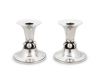 1007
A pair of Georg Jensen U.S.A. sterling silver candlesticks
Designed by Alphonse La Paglia (1907-1953)
Mid-20th century
Each marked: LaPaglia / Georg Jensen, Inc. / U.S.A. / Sterling / L.P. / 116
2 pieces
Each: 4" H x 3.75" Dia.
Total weight: 14.2 oz. troy approximately
Estimate: $700 - $900