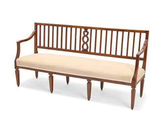 1219
An Italian Neoclassical style walnut settee
Late 19th century
With slatted back, curvilinear armrests, and tapered legs, upholstered in a cream fabric with passementerie trim
35" H x 69" W x 21.5" D
Estimate: $600 - $800