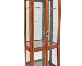 1318
A Glenn of California wood display case
Late 20th century
With an upper burlwood accent panel above the glazed cabinet doors revealing a mirrored back, three adjustable glass shelves, and one wood shelf, the interior illuminated, electrified
82" H x 32.5" W x 15.25" D
Estimate: $400 - $600
