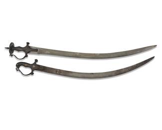 1124
Two Indo-Persian 'shamshir' swords
18th century
Shorter with faint inscription to blade
One with gilt accents to hilt
2 pieces
Longer: 35.75" L, blade 30.25" L, hilt 4.5" W; Shorter: 32" L, blade 27" L, hilt 4.125" W
Estimate: $800 - $1,200