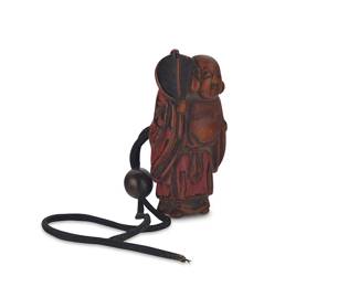 1031
An East Asian lacquered boxwood figural netsuke
18th/19th century or later; likely Japan
Possibly depicting Budai/Hotei
2.375" H x 1.25" W x 0.625" D
Estimate: $400 - $600