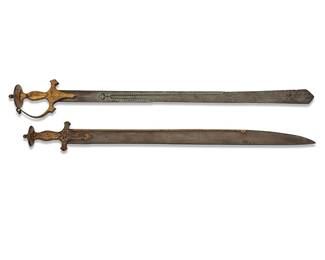 1133
Two Indian 'tulwar' swords
17th/18th century
One with gilt inscription along blunt end of blade
Each with gilt hilt
2 pieces
Larger: 36" L, blade 30" L, hilt 5" W; Shorter: 33" L, blade 27.5" L, hilt 3.375" W
Estimate: $1,000 - $1,500