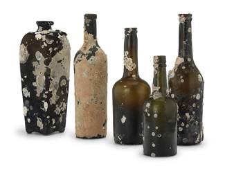 1203
A collection of glass spirit bottles
18th/19th century
One with wax seal, possibly reading: AH
With marine encrustations, each raised on an acrylic plinth
5 pieces
Tallest: 12" H x 3.25" Dia.; Shortest: 8.5" H x 3" Dia.
Estimate: $150 - $250