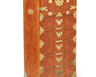 1328
A Contemporary Korean burlwood chest
Late 20th century
The chest with gilt metal hardware, opposed handles, and butterfly escutcheons, featuring an upper component with hinged locking cabinet doors revealing six small drawers, above five larger drawers below, raised on ogee bracket feet
52.25" H x 23.5" W x 16.75" D
Estimate: $100 - $200