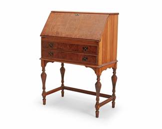 1332
A William & Mary style slant front writing desk
Early 20th century
The wood desk with locking hinged drop front writing surface opening to reveal five letter compartments above two small drawers, all above two longer drawers with batwing escutcheon pulls, raised on fluted baluster-form legs joined by three stylized bar stretchers
41.25" H x 30" W x 17" D
Estimate: $100 - $200